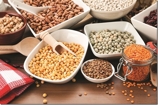 arrangement of various legumes in bowls on table