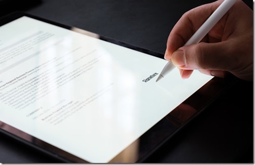 Businessman Signing Electronic Contract On Digital Tablet