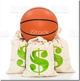 Concept-NBA Lockout. Basketball sitting on money bags against a white background