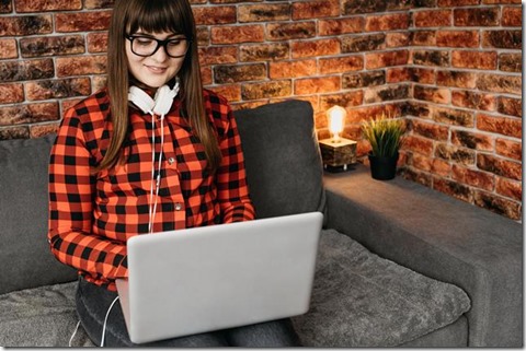 female-blogger-with-headphones-streaming-online-with-laptop