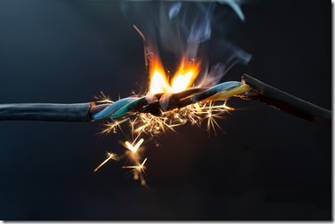 flame smoke and sparks on an electrical cable, fire hazard concept