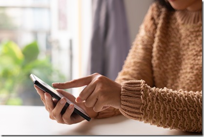 Close-up of girl in sweater viewing online information