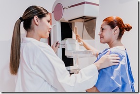 Doctor doing mammogram exam on patient at hospital