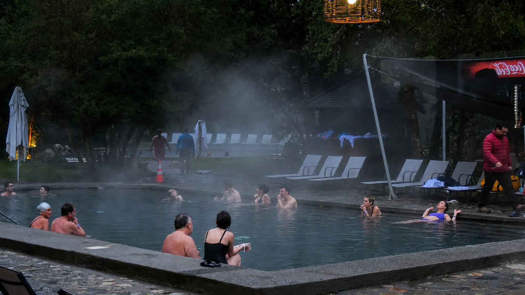 Visitantes disfrutando de las aguas termales en los parques de Pucón durante el invierno