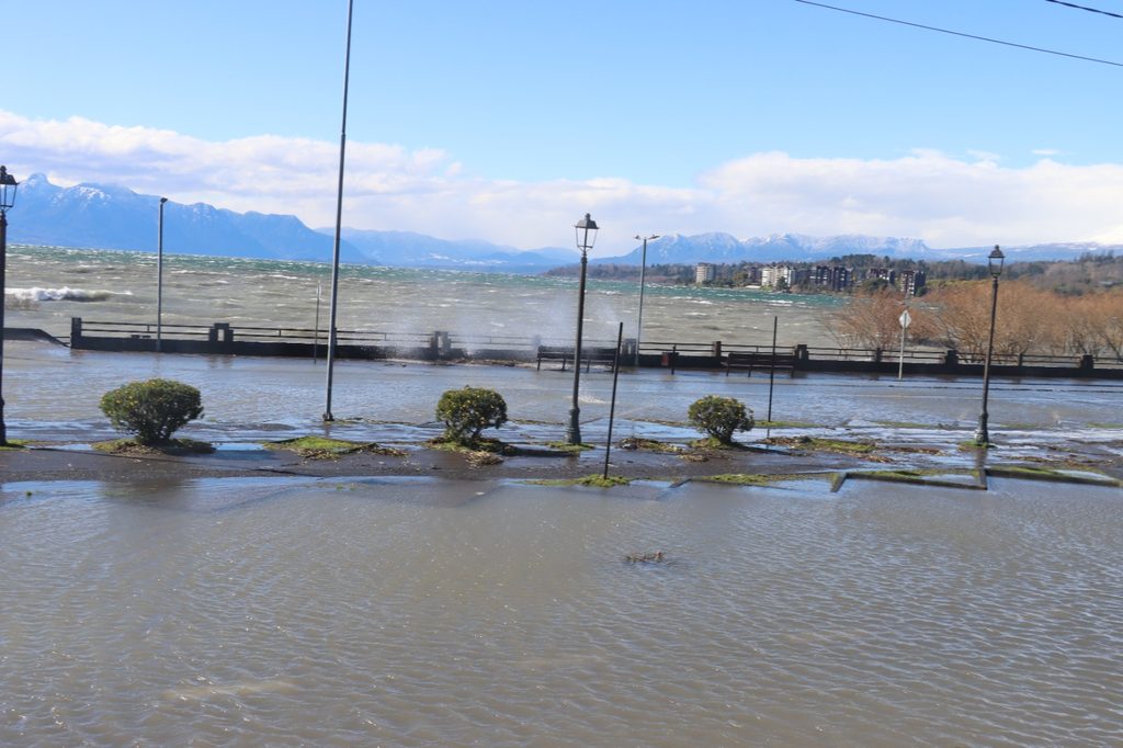 Trabajadores municipales retirando ramas y residuos en la Costanera de Villarrica tras el fuerte oleaje