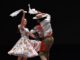 Pareja bailando cueca chilena en un entorno cultural universitario