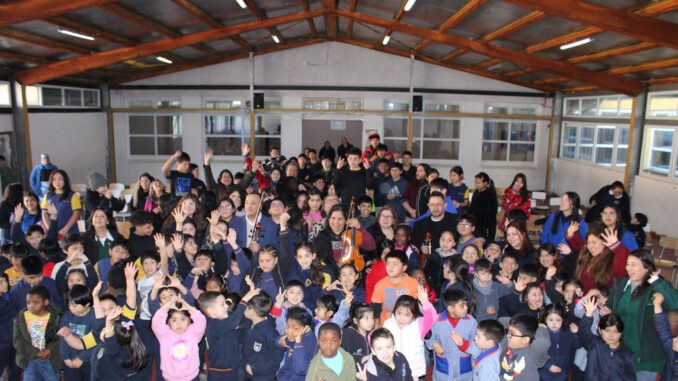 Estudiantes de la Escuela Standard interactuando con músicos de la Orquesta Filarmónica de Temuco en una jornada educativa.