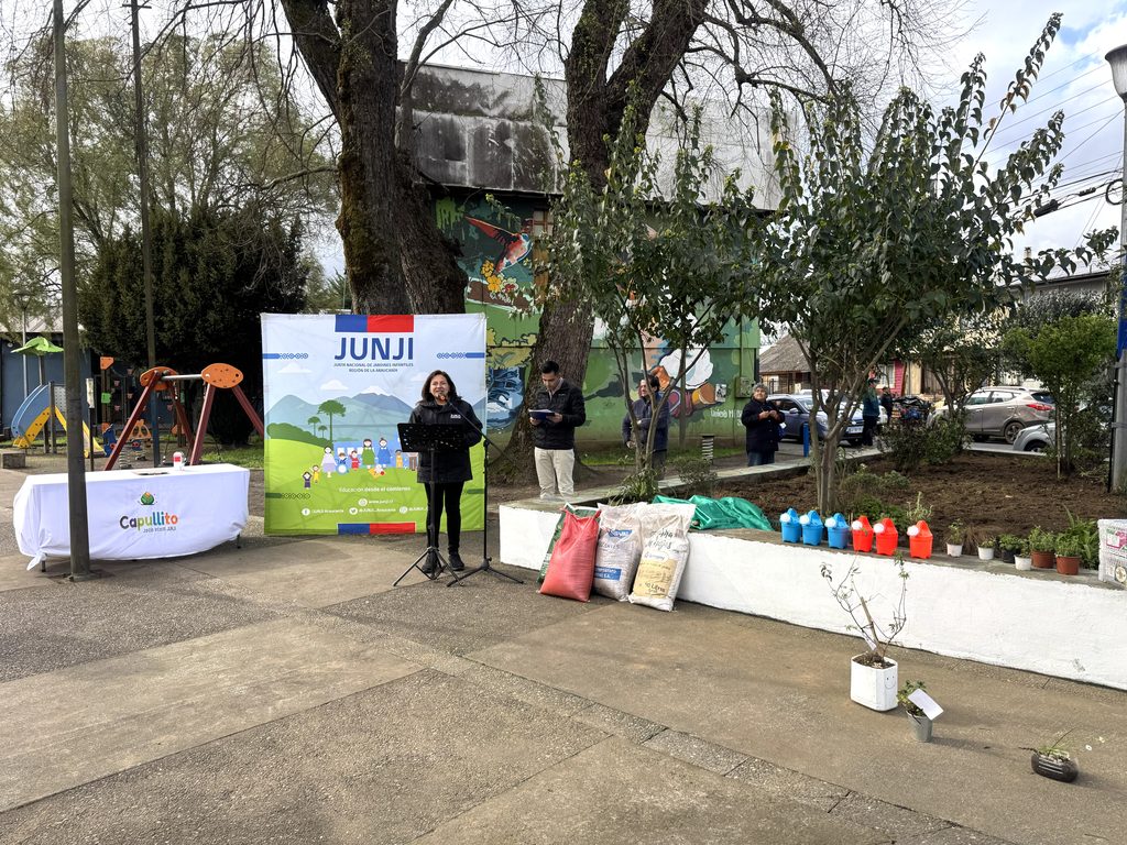 Niños y vecinos participando en la reactivación del huerto medicinal del Jardín Infantil Capullito en Temuco